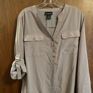 Tan blouse with adjustable sleeves.